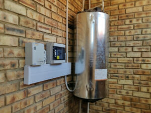 An image of a geyser (electric water heater) with an Elon 100 solar PV water heating unit.